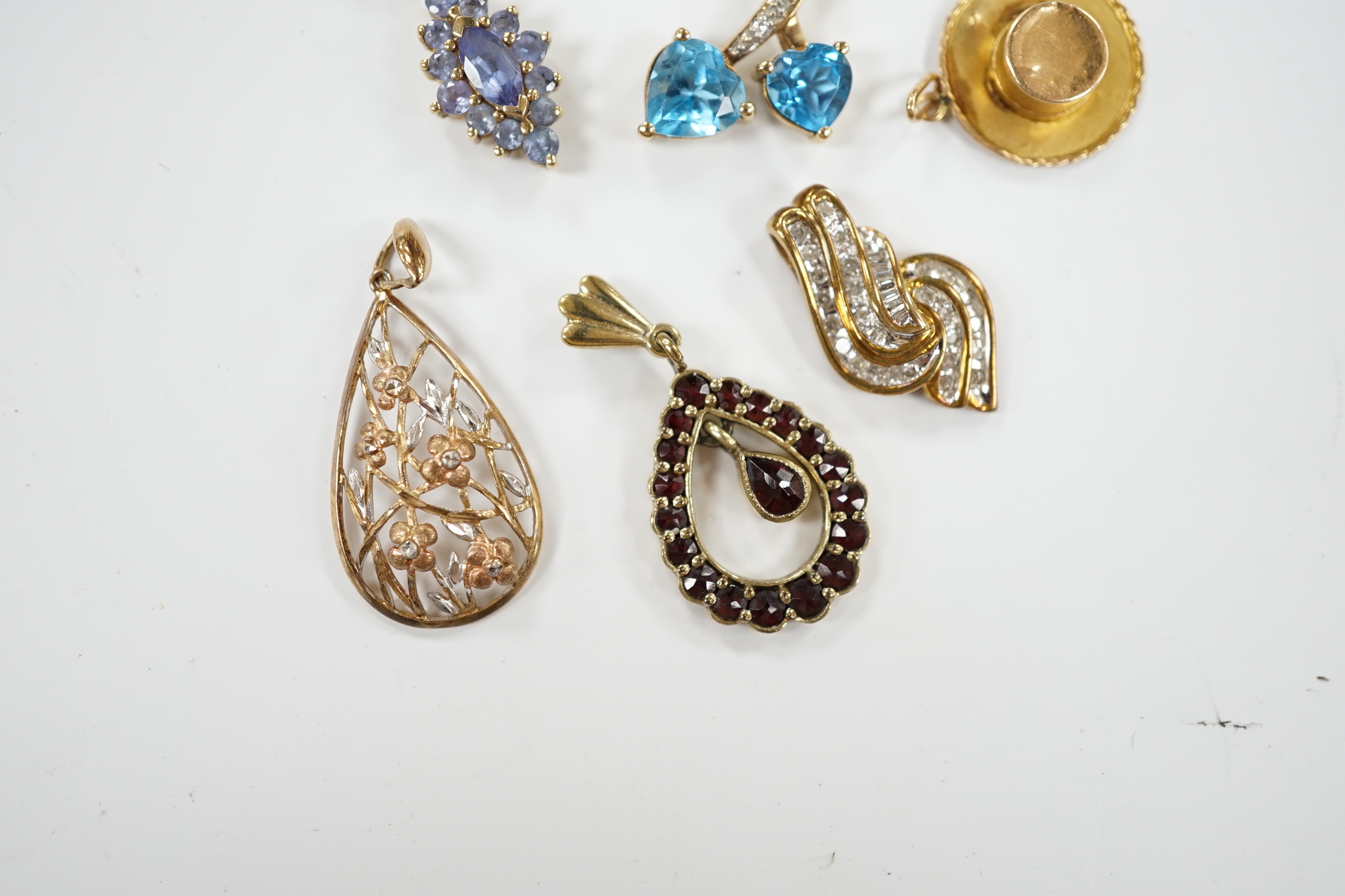 Seven assorted modern mainly 9ct and gem set small pendants, including diamond chip cluster, gross weight 10.4 grams.